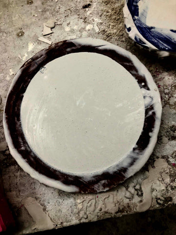 plaster in a circular black rubber mold