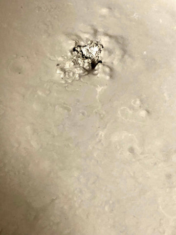 closeup of plaster in a bucket, almost completely mixed