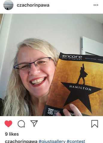 Instagram screenshot of closeup of woman holding Hamilton musical playbill with white wall behind
