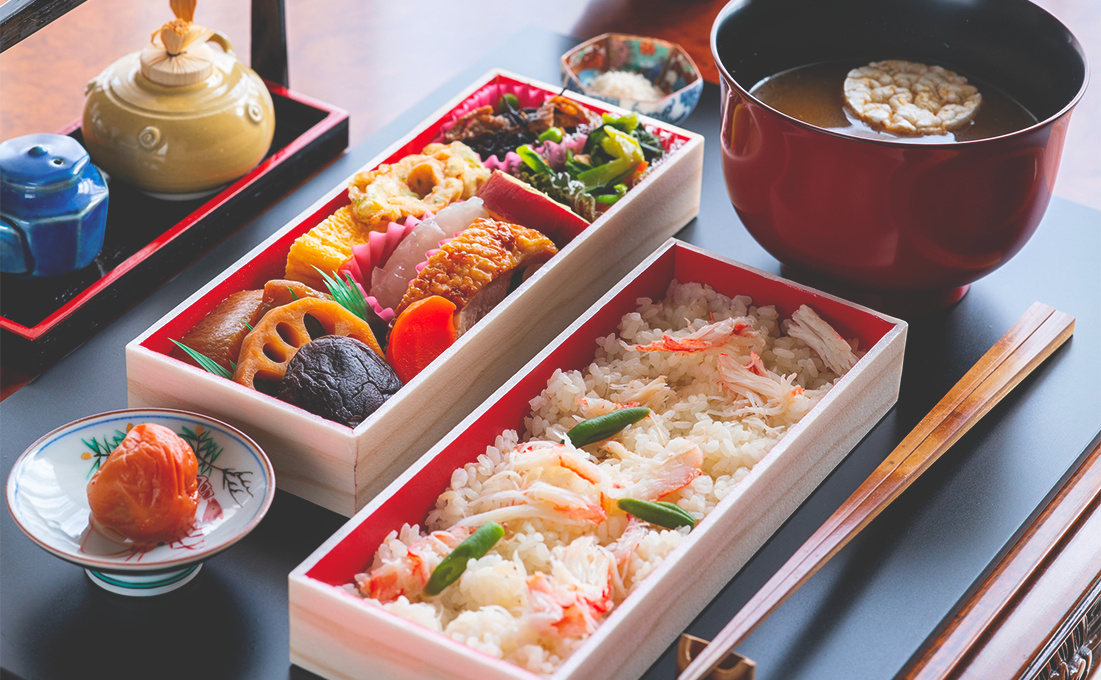 Photo of osechi, two bento boxes filled with an assortment of traditional Japanese food