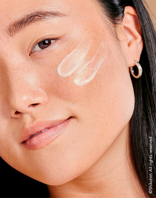 A picture of 5 Mushroom Moisturizer getting used on an asians lady face to show the consistency of the  moisturizer