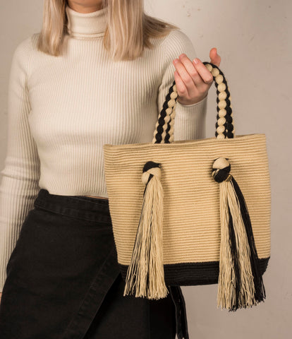 Model holds the CHILA BAGS Juanma tassel tote bag.