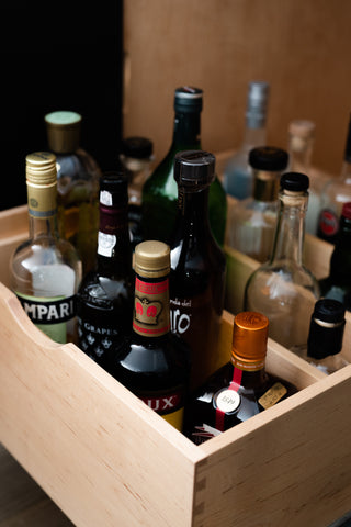 Liquor drawer that pulls out of cabinet with rows of storage