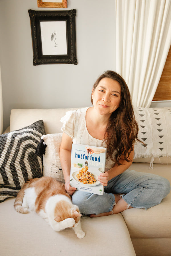 Lauren Toyota for Salt Spring Kitchen Company portrait on the couch with cookbook hot for food all day