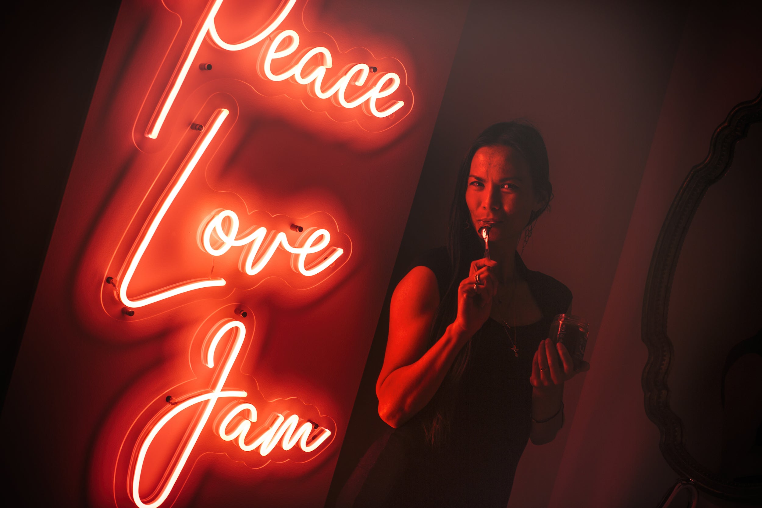 Salt Spring Kitchern Company Neon Peace Love Jam with woman eating jam