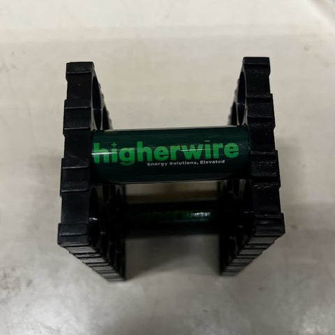 A Higherwire-branded 18650 cell in a holder bracket.