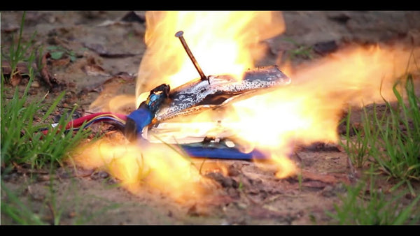 A lithium battery on fire after being punctured by a nail