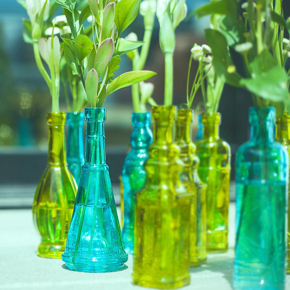 https://cdn.shopify.com/s/files/1/0469/3629/3530/products/turquoise-vintage-glass-bottle-marguerite-glassware-flower-vase-image-1_1600x.jpg?v=1603772251