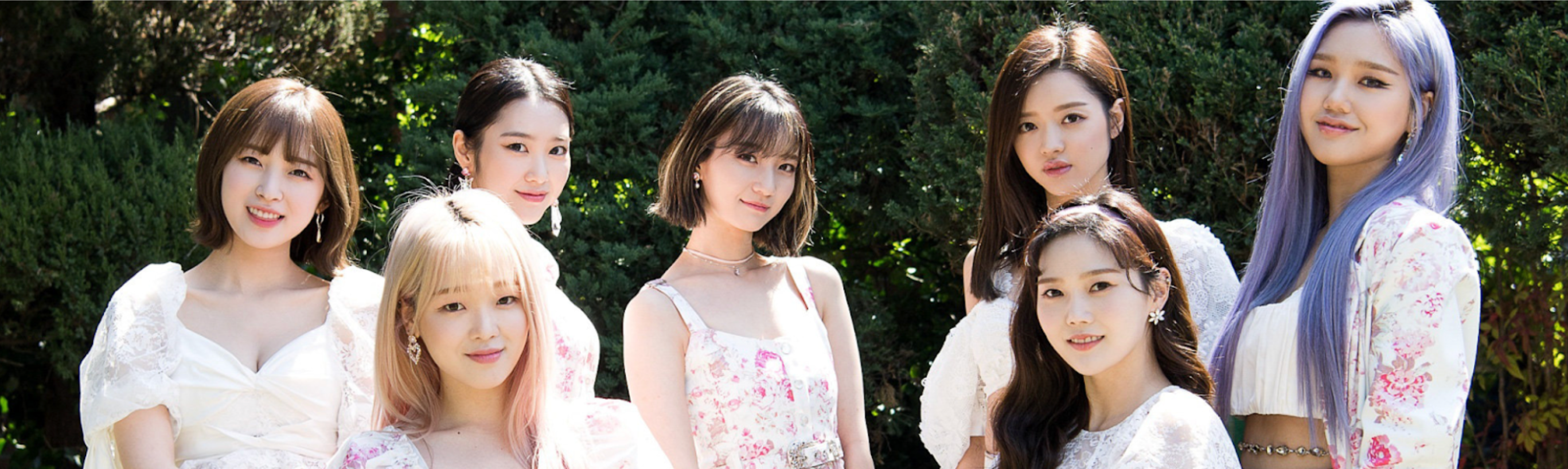 oh my girl naver x dispatch pictorial, the 7 members wearing white floral dresses and standing together in front of trees