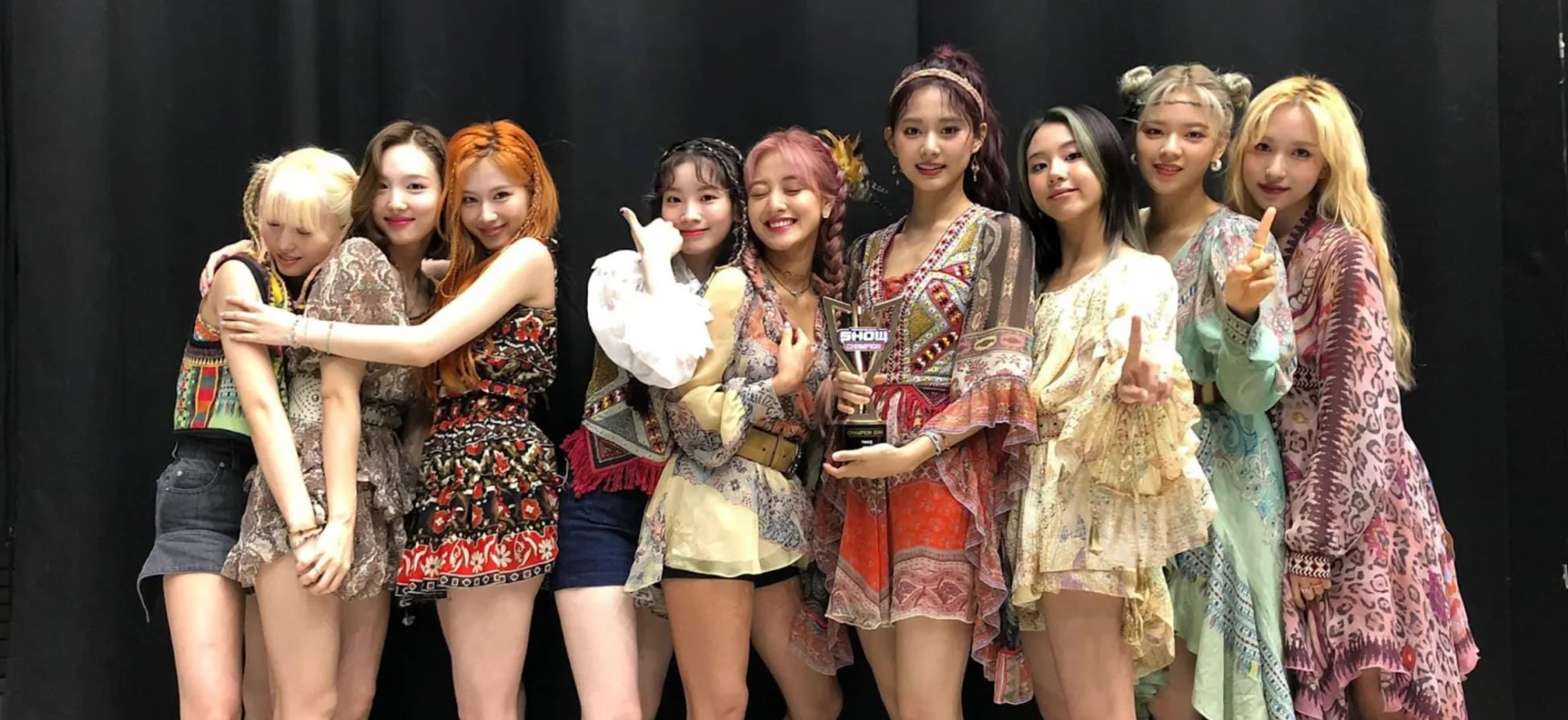 twice holding a music show trophy (more and more promotions)