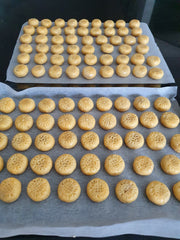 Freshly made uncooked bite sized pineapple tarts on trays ready to put in the oven.