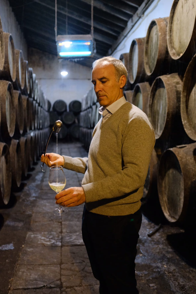 Jose Luis Barrero pouring a glass of Manzanilla using a Venencia at M. Sanchez Ayala Bodegas Barrero 1798 in Sanlucar de Barrameda