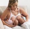 women breastfeeding two babies football hold