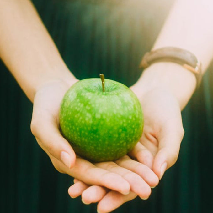 green apple in a girls hand