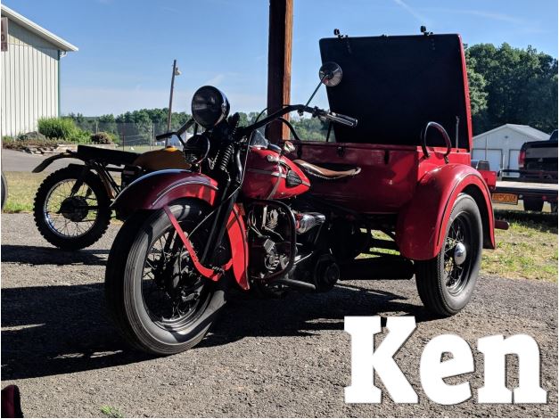 Ken<br><br>Well folks, this is where it all started! In 1977, Ken traded his jeep for this 1945 servi-car, although back then, it looked a bit different.  He agreed to trade the jeep for a Harley, site unseen, and when he got it, saw it had been cut in half with an indian rear end welded on. Turns out, it was a servi-car that moonlighted as a hill climber for a short time!  Many years later, Kenny finally restored it to its original servi-car glory and has been riding it ever since.  This bike has won him many awards, and we sometimes joke that he loves it more than his own kids!<br><br>Ken has always been fascinated with how things work, and over the years has learned to fix anything with an engine. Ken has been building and buying trikes for most of his life, teaching himself how to  maintain them along the way. We are grateful that he is showing us everything he knows about these gems. He is known to us as the original “Trike Guy”!
