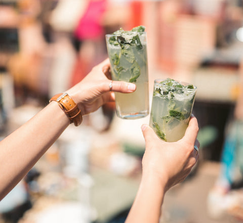 mojitos being held in the air