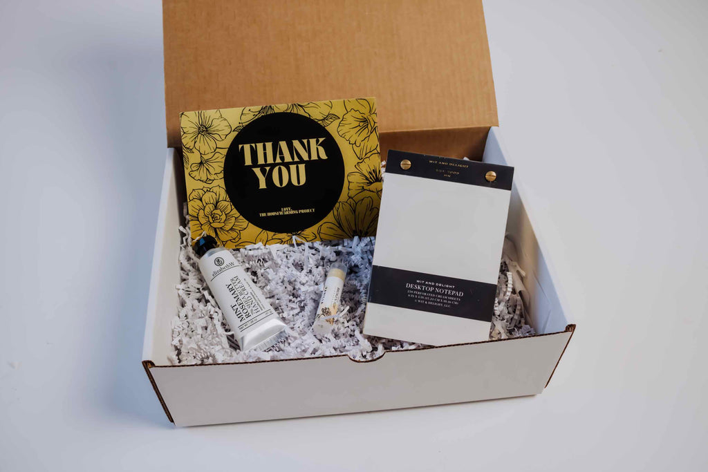 Corporate Gift box with a thank you note including candle, matches and lotion.