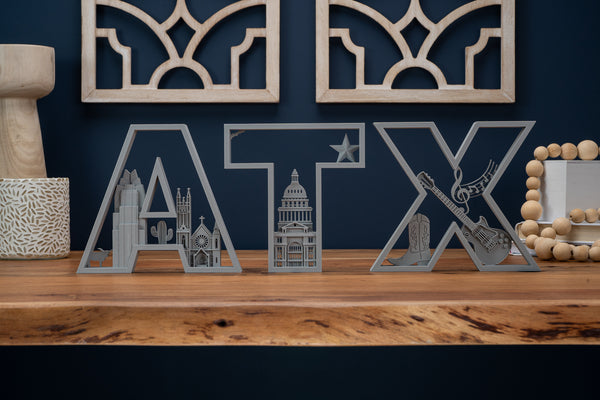 3D printed ATX set in a home decor setting. Letters feature landmarks from Austin, Texas