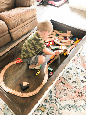 little boy playing in train table - how to encourage independent play