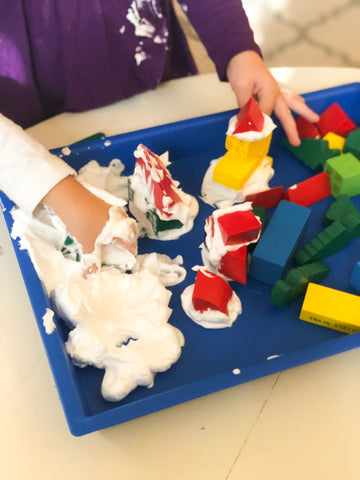 activity tray filled with shaving cream and blocks for preschoolers to build using blocks and shaving cream