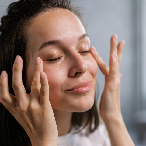 A Lady applying eye serum to her face