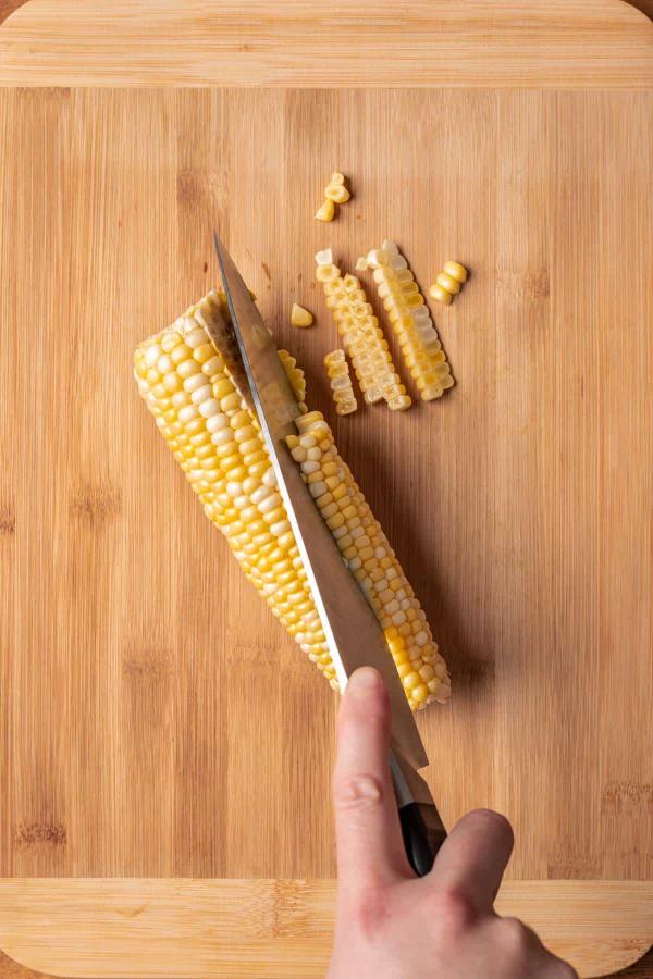 Cutting corn off the cob with a kitchen knife