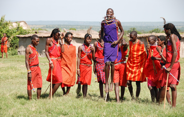 Maasai Men wearing the symbolic maasai shuka as they perform their traditional dance