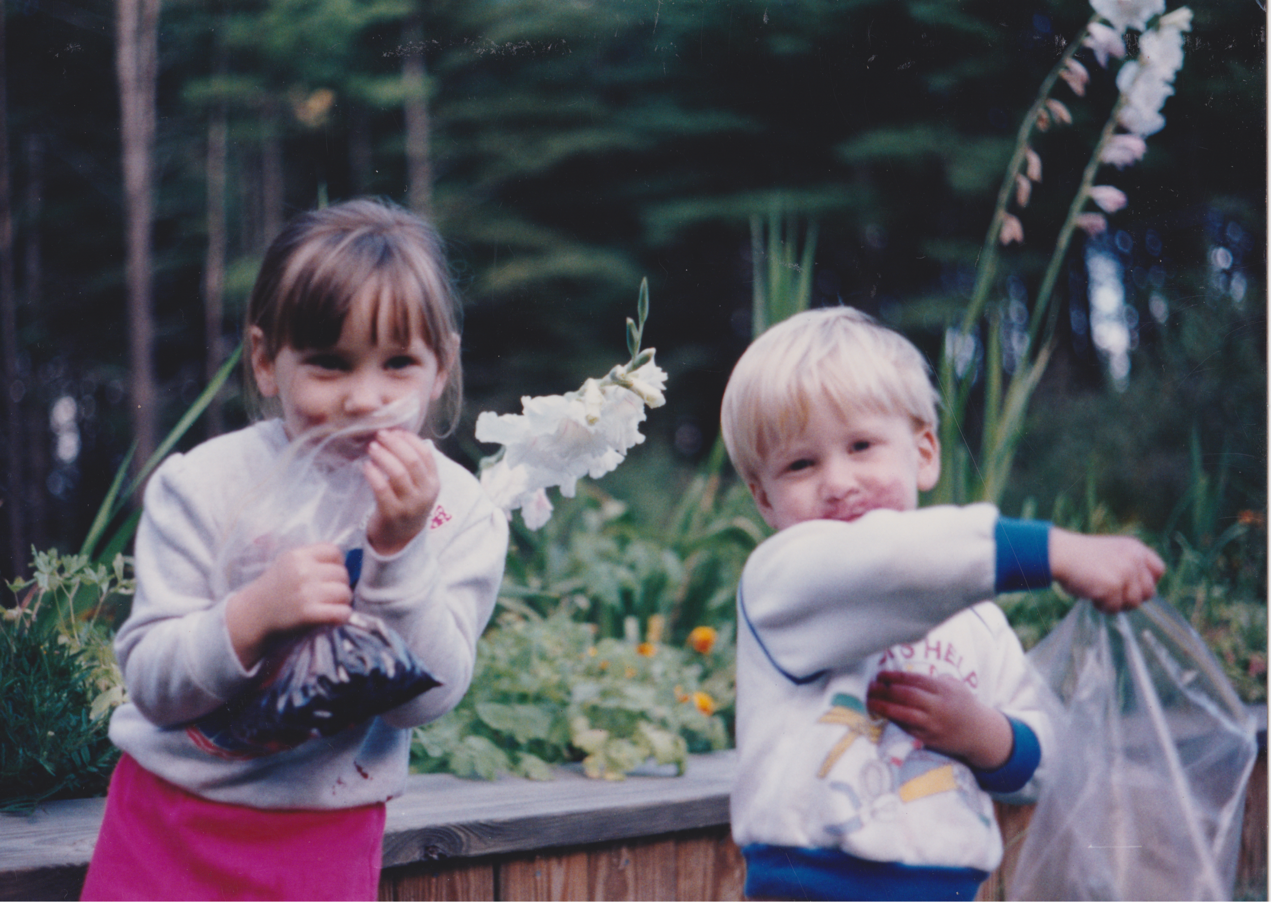 Curtis and Caitlyn covered in blackberries at home in front of flowers