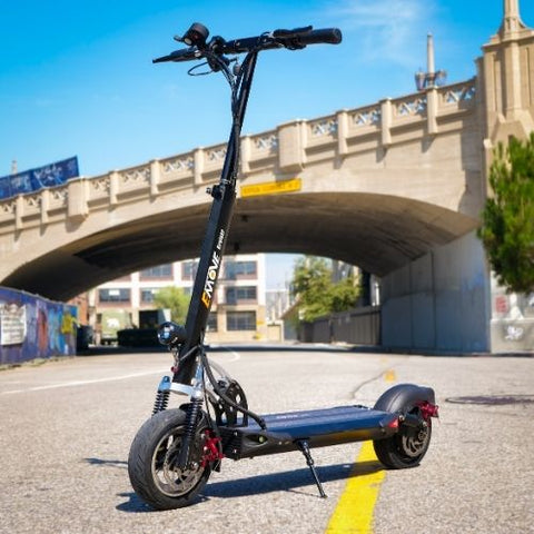 EMOVE Electric Cruiser Scooter standing on a road under a bridge