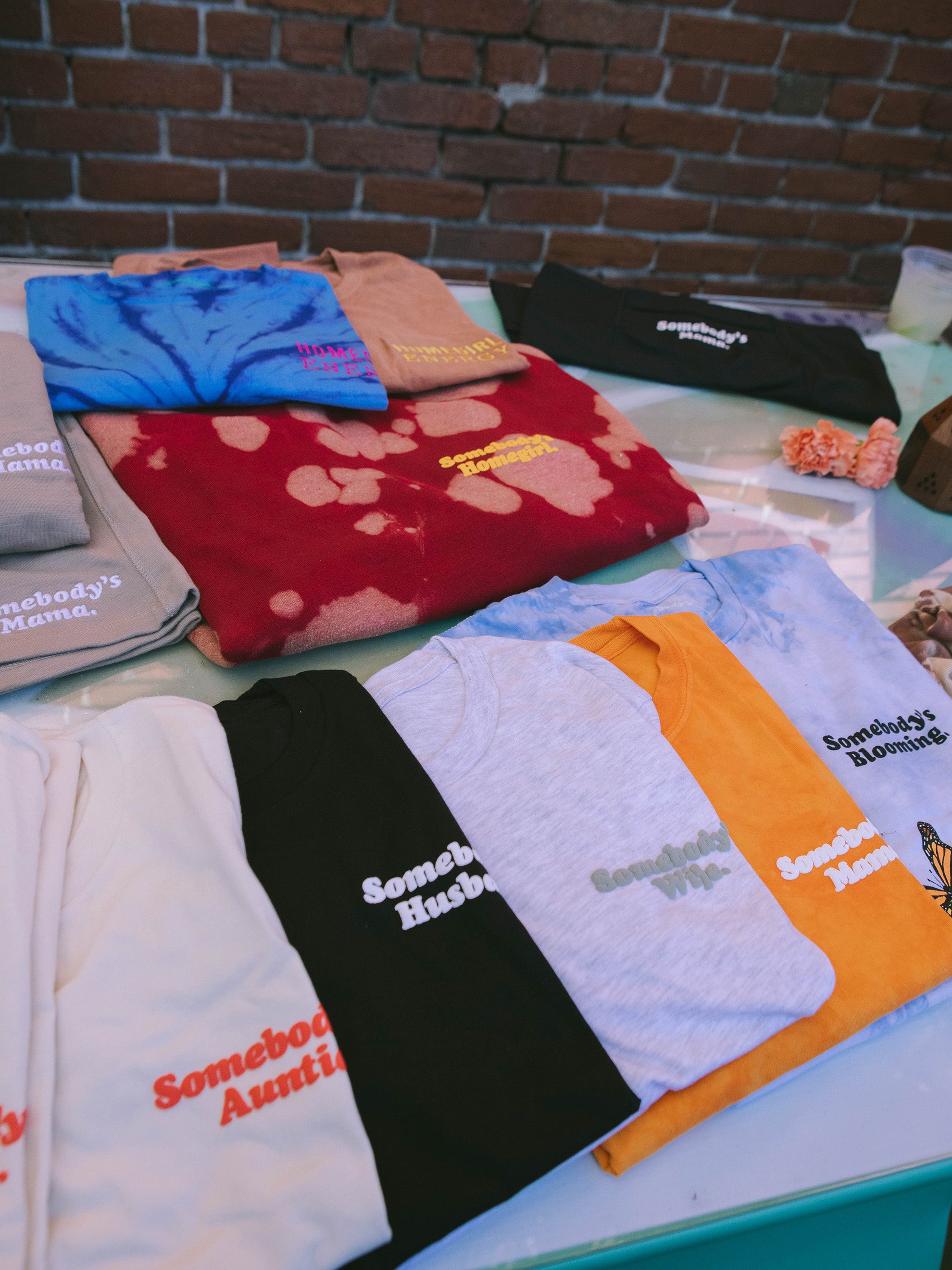 MindfulFee shirts and crewnecks laid out on table