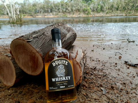 Dugite Whiskey bottle near the river