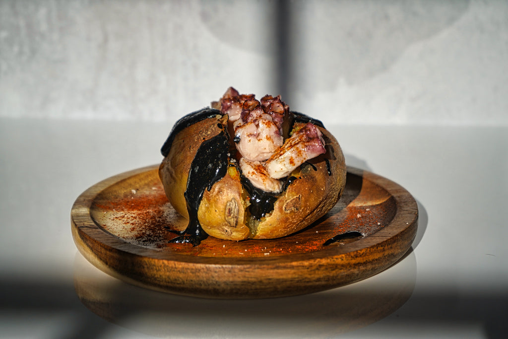 Yukon potato with octopus and drizzle of squid ink 