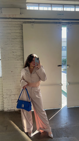 latin fashion brands, shop semiya, blue leather eileen baguette bag with carolina alatorre earrings from mexico city and wearing a beige suite