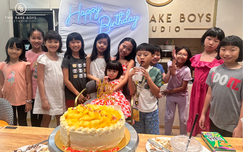 Group of Kids Celebrating A Themed Birthday With A Cake