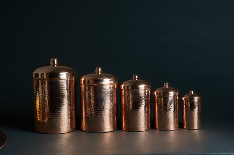 Different sizes of copper kitchen canisters