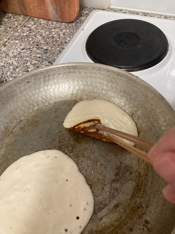Flip pancakes when bubbles form
