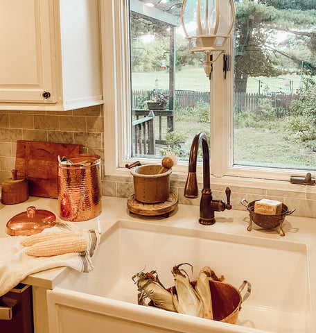 Farmhouse kitchen with copper kitchen composting canisters