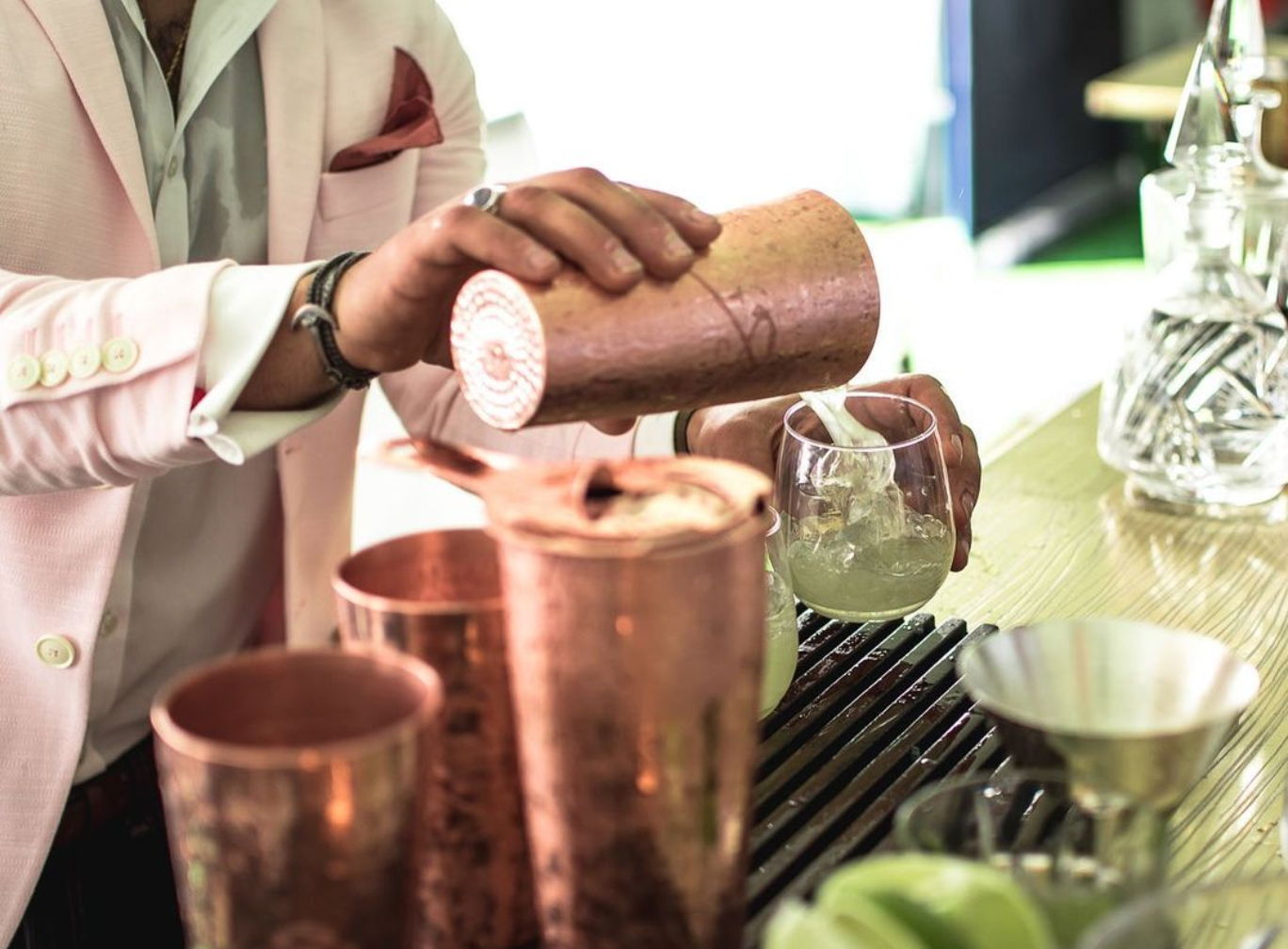 Pour Cocktail From Boston Shaker To Glass With Rocks