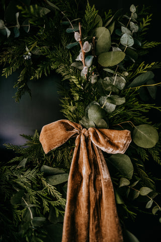 gold velvet ribbon on cedar and eucalyptus wreath making event workshop class