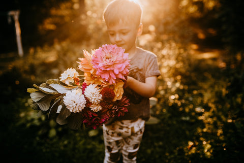 little boy holding flowers