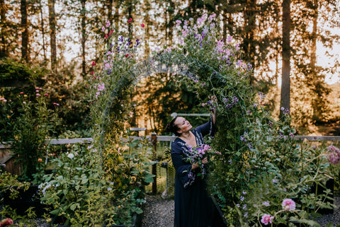 gardener in her garden sweet peas flower cottage garden