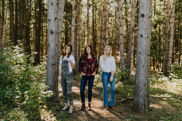 Photos of Three Models Standing in Woods