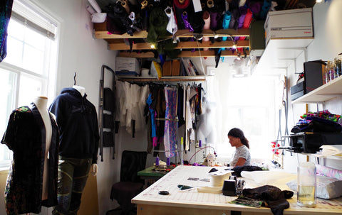 Nina Jones aka Nina J Skates sits at her sewing machine in her studio in East Vancouver, surrounded by her creations.