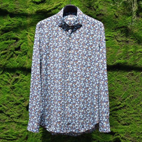 Image of Orian shirt hanging in front of garden