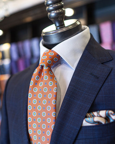 Picture of ZZegna Navy Glencheck Suit with Canali Orange Medallion Tie on a mannequin