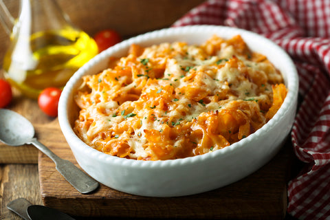 Macaroni and cheese in a white baking dish on a table