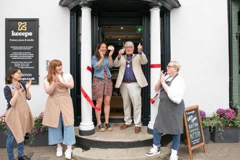 opening pottery store cutting ribbon