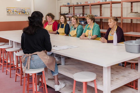 group taking a pottery class