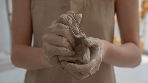 clay hands in pottery class