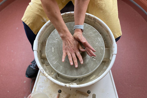 throwing pottery at the potters wheel